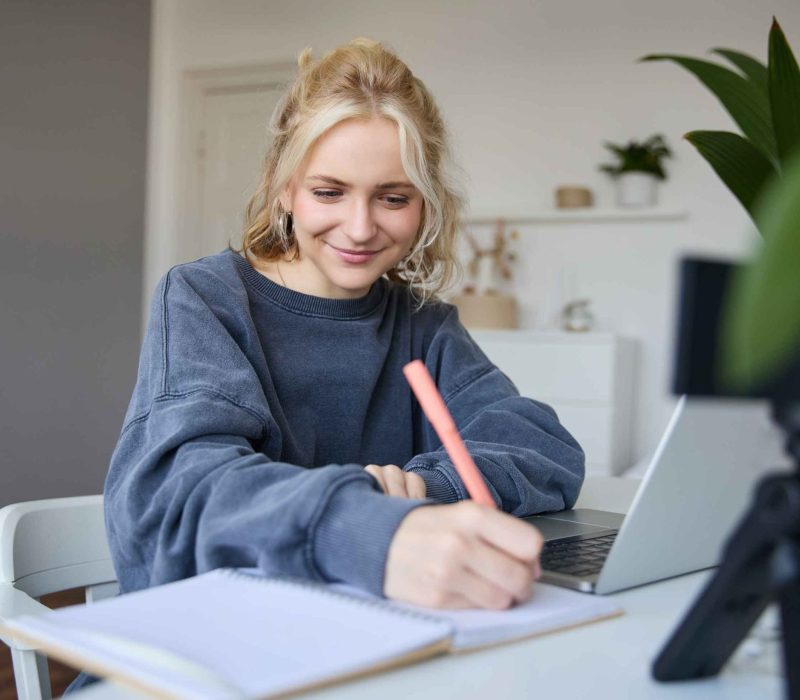 portrait-young-woman-lifestyle-blogger-recording-video-herself-making-notes-writing-journal