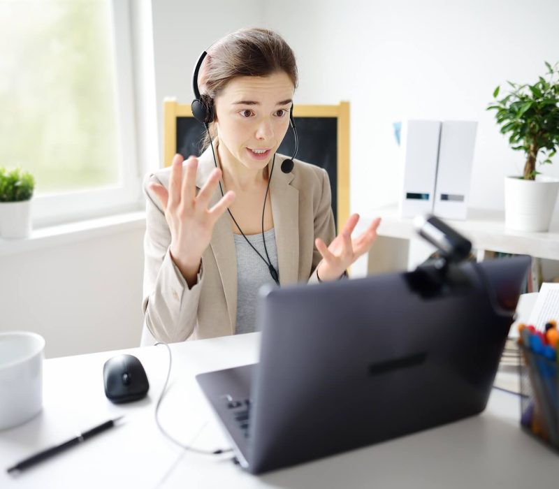 young-woman-is-learning-language-with-laptop-computer-camcorder-and-headphone-online-at-home-.jpg